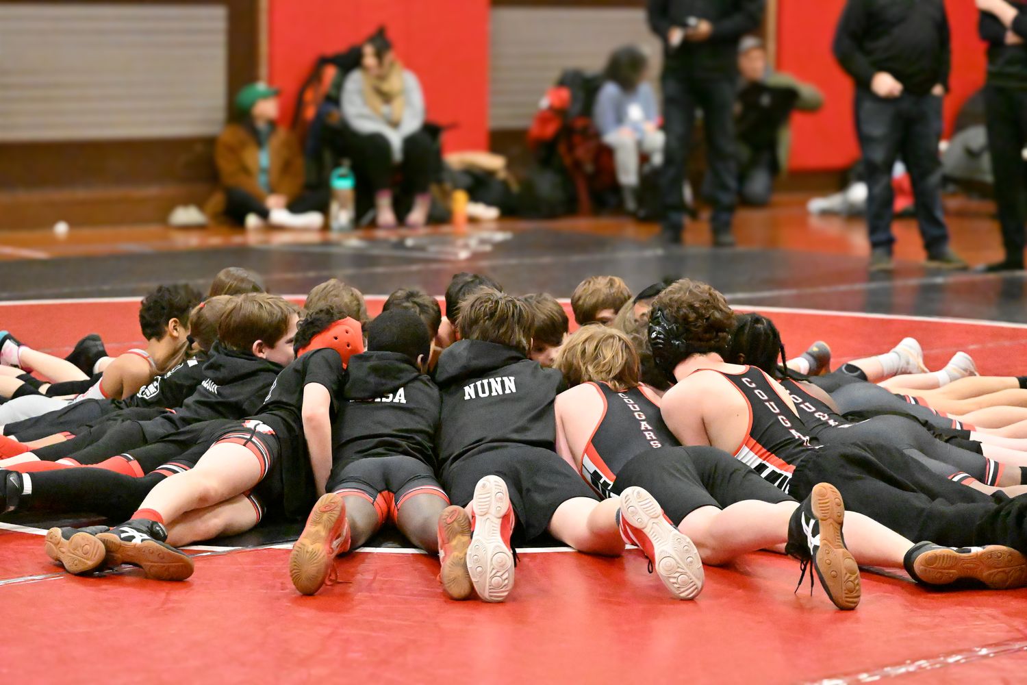 The whole MSO team piled into a huddle on the mat, heads together.